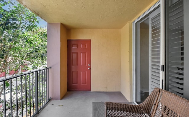 700 Scotia Dr Unit 202, Hypoluxo, FL 33462 - entrance to property with a balcony and stucco siding