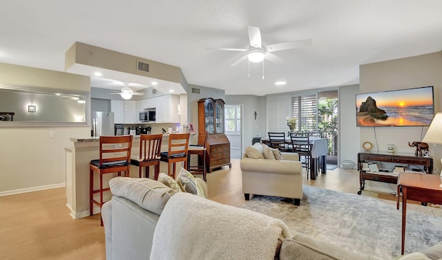 700 Scotia Dr Unit 202, Hypoluxo, FL 33462 - living area featuring ceiling fan, light wood-style flooring, and baseboards