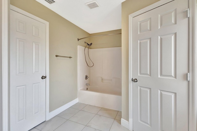 1897 SW Lofgren Ave, Port Saint Lucie, FL 34953 - bathroom featuring  shower combination, baseboards, and tile patterned flooring