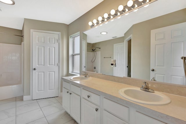 1897 SW Lofgren Ave, Port Saint Lucie, FL 34953 - full bathroom featuring double vanity and baseboards