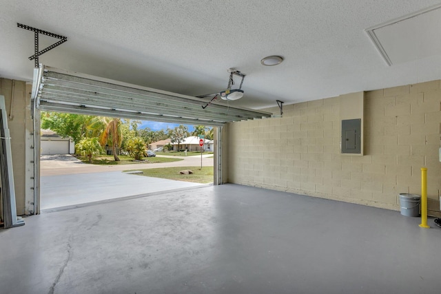 1897 SW Lofgren Ave, Port Saint Lucie, FL 34953 - garage featuring electric panel, concrete block wall, and a garage door opener