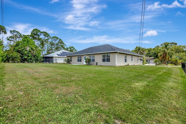 1897 SW Lofgren Ave, Port Saint Lucie, FL 34953 - rear view of property featuring stucco siding
