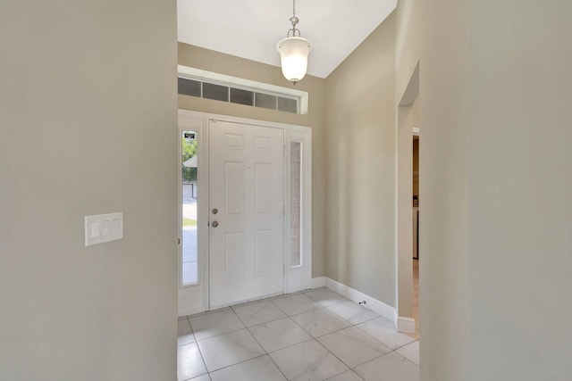 1897 SW Lofgren Ave, Port Saint Lucie, FL 34953 - entryway featuring light marble finish flooring and baseboards