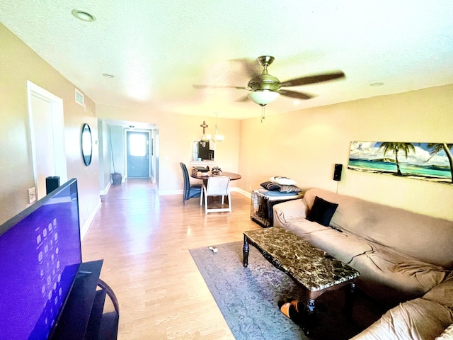 829 Camino Rd Unit 206-C, Delray Beach, FL 33445 - living area featuring light wood finished floors, a ceiling fan, baseboards, and a textured ceiling