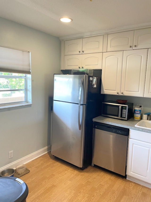 829 Camino Rd Unit 206-C, Delray Beach, FL 33445 - kitchen with stainless steel appliances, white cabinetry, light countertops, a sink, and recessed lighting