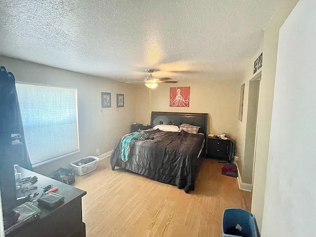 829 Camino Rd Unit 206-C, Delray Beach, FL 33445 - bedroom featuring wood finished floors, a textured ceiling, a ceiling fan, and baseboards