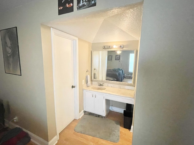 829 Camino Rd Unit 206-C, Delray Beach, FL 33445 - bathroom featuring wood finished floors, vanity, ensuite bath, and baseboards