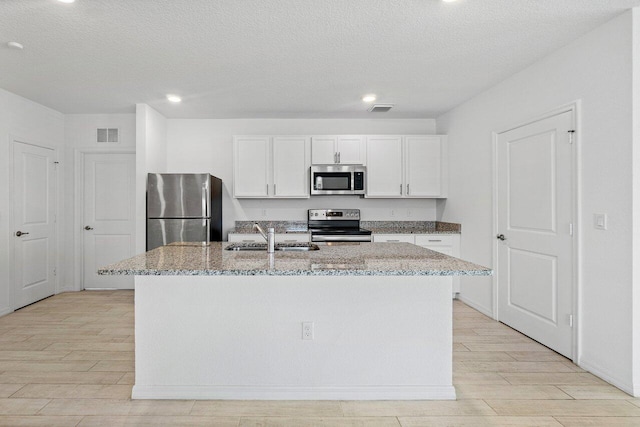 5174 Armina Pl, Fort Pierce, FL 34951 - kitchen featuring stainless steel appliances, a sink, light stone countertops, light wood finished floors, and recessed lighting