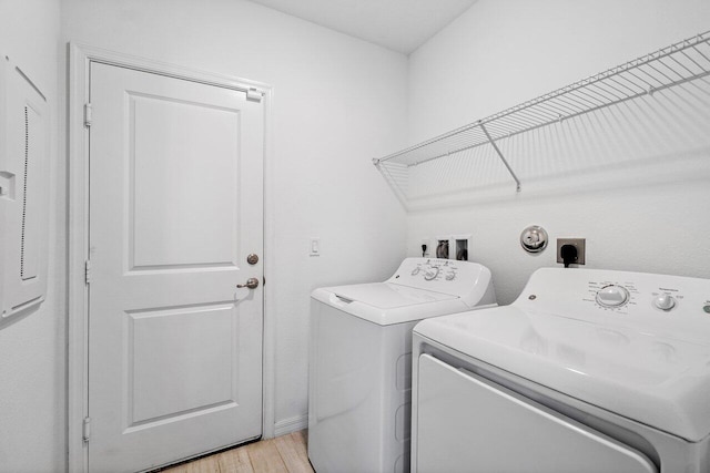 5174 Armina Pl, Fort Pierce, FL 34951 - laundry room with washing machine and clothes dryer and light wood-type flooring