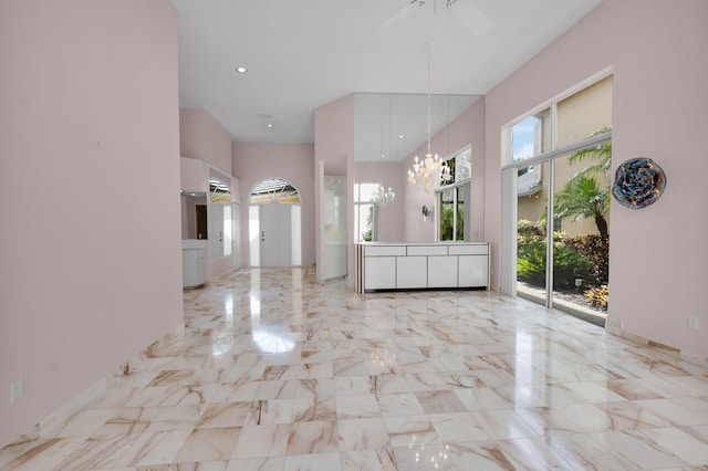 7729 Travlers Tree Dr, Boca Raton, FL 33433 - interior space featuring a towering ceiling, a chandelier, marble tiled flooring, and a ceiling fan