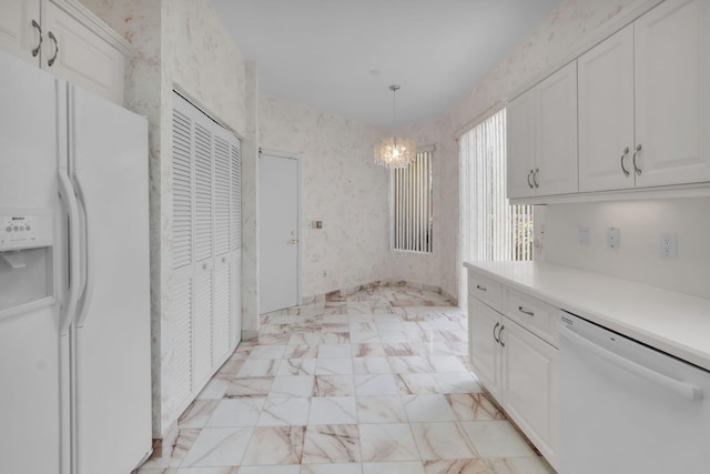 7729 Travlers Tree Dr, Boca Raton, FL 33433 - kitchen with white appliances, white cabinets, a chandelier, and light countertops
