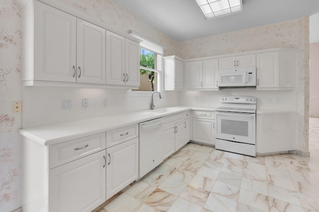7729 Travlers Tree Dr, Boca Raton, FL 33433 - kitchen with white appliances, a sink, white cabinets, light countertops, and wallpapered walls