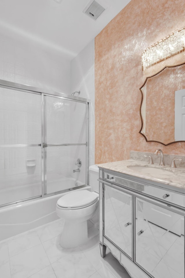 7729 Travlers Tree Dr, Boca Raton, FL 33433 - bathroom with vanity, toilet, combined bath / shower with glass door, and marble look tiles