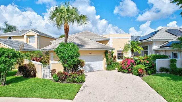 7729 Travlers Tree Dr, Boca Raton, FL 33433 - view of front of house with stucco siding, an attached garage, driveway, a gate, and a tile roof