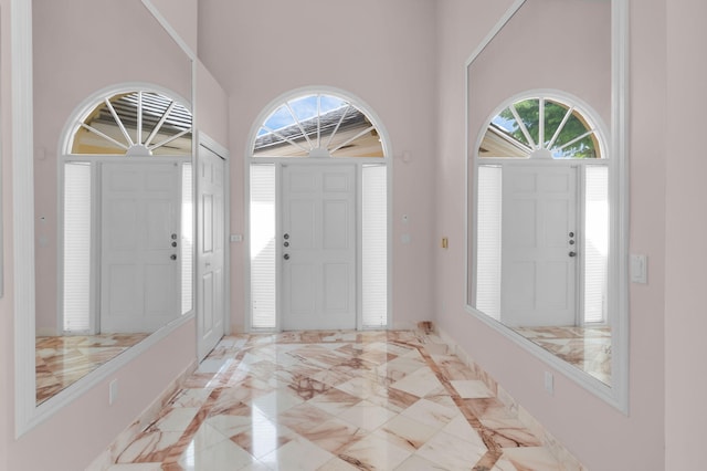 7729 Travlers Tree Dr, Boca Raton, FL 33433 - entryway featuring light marble finish floors, a high ceiling, and baseboards
