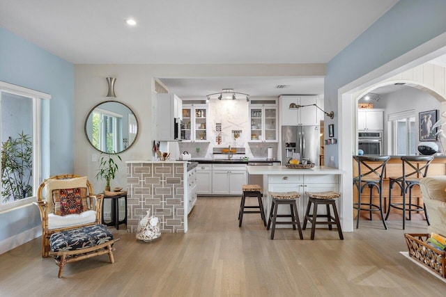 164 Bryn Mawr Dr, Lake Worth Beach, FL 33460 - kitchen featuring appliances with stainless steel finishes, plenty of natural light, white cabinetry, a kitchen breakfast bar, and recessed lighting