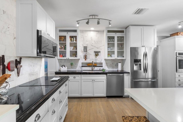 164 Bryn Mawr Dr, Lake Worth Beach, FL 33460 - kitchen with appliances with stainless steel finishes, decorative backsplash, glass insert cabinets, and white cabinetry