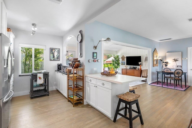 164 Bryn Mawr Dr, Lake Worth Beach, FL 33460 - kitchen with stainless steel refrigerator with ice dispenser, light wood finished floors, an office area, and a breakfast bar area