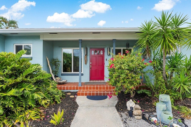 164 Bryn Mawr Dr, Lake Worth Beach, FL 33460 - view of exterior entry featuring stucco siding and covered porch