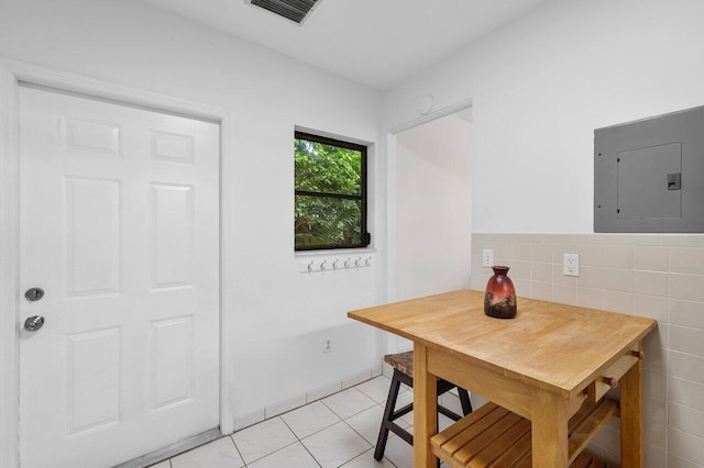 164 Bryn Mawr Dr, Lake Worth Beach, FL 33460 - dining space featuring electric panel, light tile patterned floors, and tile walls