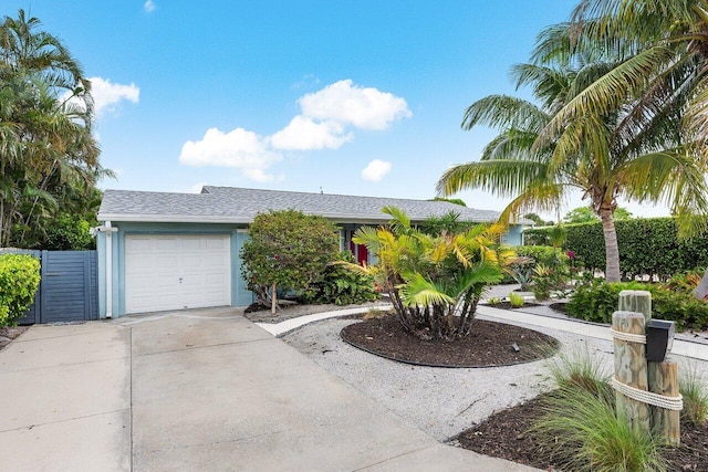 164 Bryn Mawr Dr, Lake Worth Beach, FL 33460 - view of front facade featuring driveway, an attached garage, a shingled roof, and stucco siding