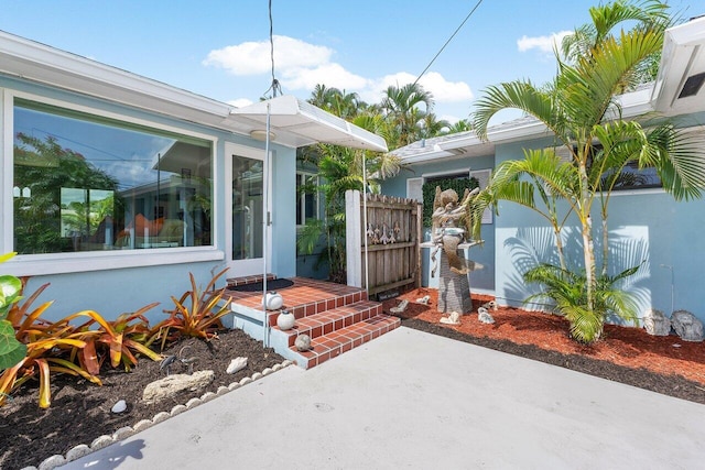 164 Bryn Mawr Dr, Lake Worth Beach, FL 33460 - doorway to property featuring stucco siding and a patio area