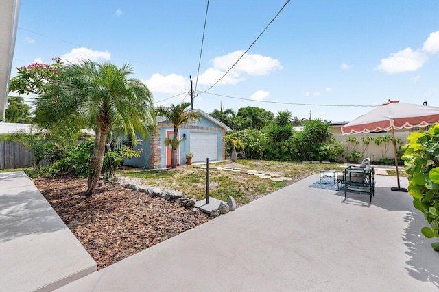 164 Bryn Mawr Dr, Lake Worth Beach, FL 33460 - view of patio featuring an outdoor structure, outdoor dining space, and a garage