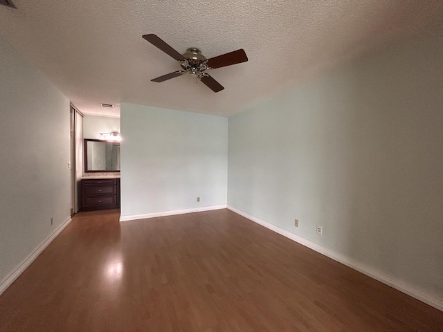 3400 NW 47th Ave Unit 3161, Coconut Creek, FL 33063 - spare room featuring dark wood-type flooring, ceiling fan, baseboards, and a textured ceiling