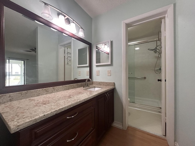 3400 NW 47th Ave Unit 3161, Coconut Creek, FL 33063 - full bath featuring a stall shower, wood finished floors, vanity, toilet, and a textured ceiling