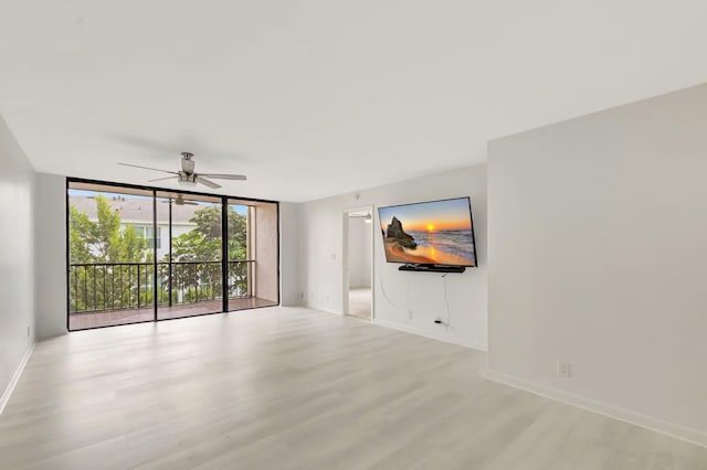 4345 Trevi Ct Unit 203, Lake Worth, FL 33467 - spare room with light wood-style floors, floor to ceiling windows, a ceiling fan, and baseboards