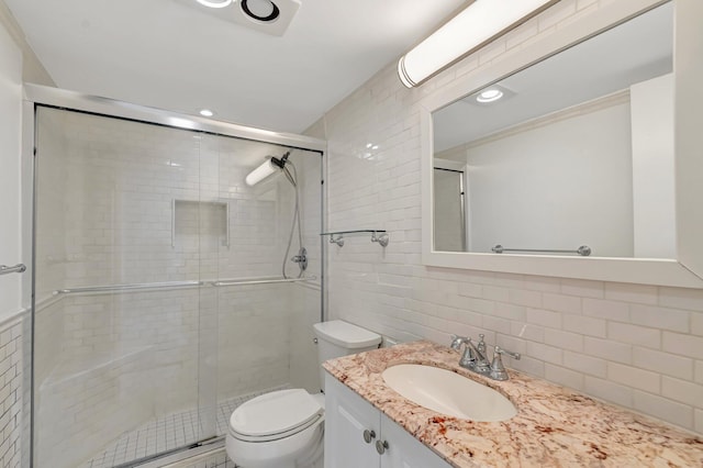4345 Trevi Ct Unit 203, Lake Worth, FL 33467 - bathroom featuring vanity, toilet, a stall shower, tile walls, and decorative backsplash