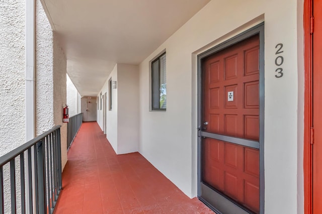 4345 Trevi Ct Unit 203, Lake Worth, FL 33467 - doorway to property with stucco siding and a balcony