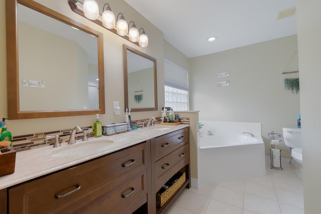 143 Monterey Way, Royal Palm Beach, FL 33411 - bathroom with toilet, double vanity, a bath, and tile patterned floors