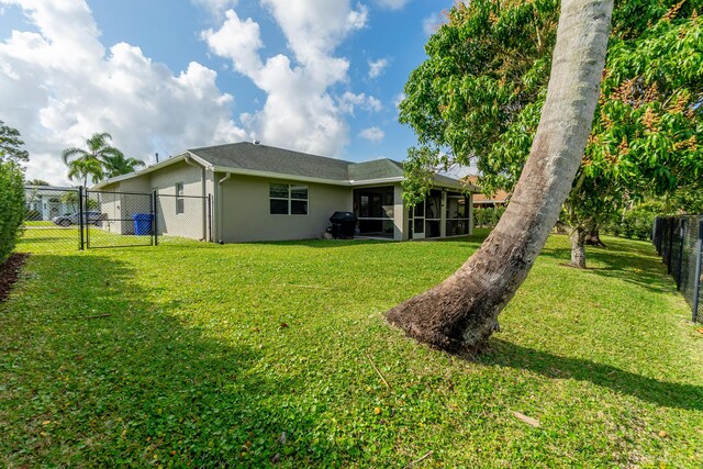 143 Monterey Way, Royal Palm Beach, FL 33411 - back of property with a sunroom, stucco siding, and a gate