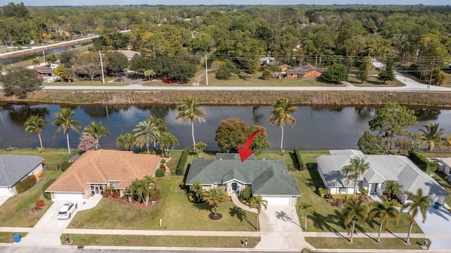 143 Monterey Way, Royal Palm Beach, FL 33411 - aerial view of residential area with a nearby body of water and a forest