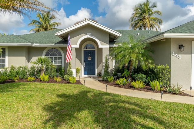 143 Monterey Way, Royal Palm Beach, FL 33411 - single story home featuring a front lawn, stucco siding, and roof with shingles