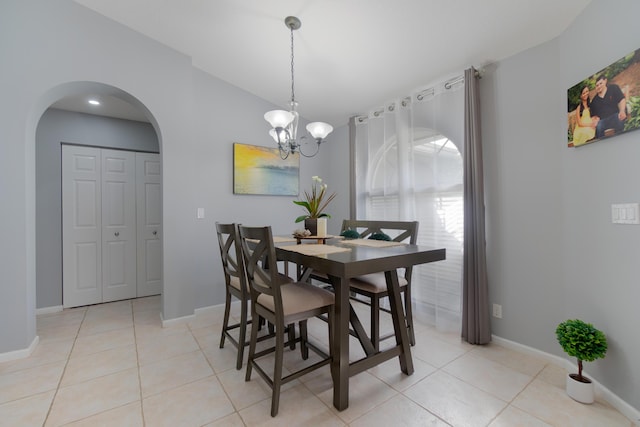 143 Monterey Way, Royal Palm Beach, FL 33411 - dining room featuring arched walkways, a chandelier, light tile patterned flooring, baseboards, and lofted ceiling