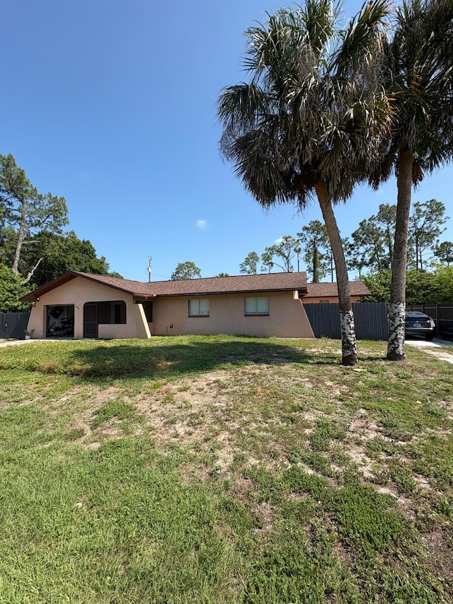 305 E 6th St, Lehigh Acres, FL 33972 - view of home's exterior with stucco siding and a garage