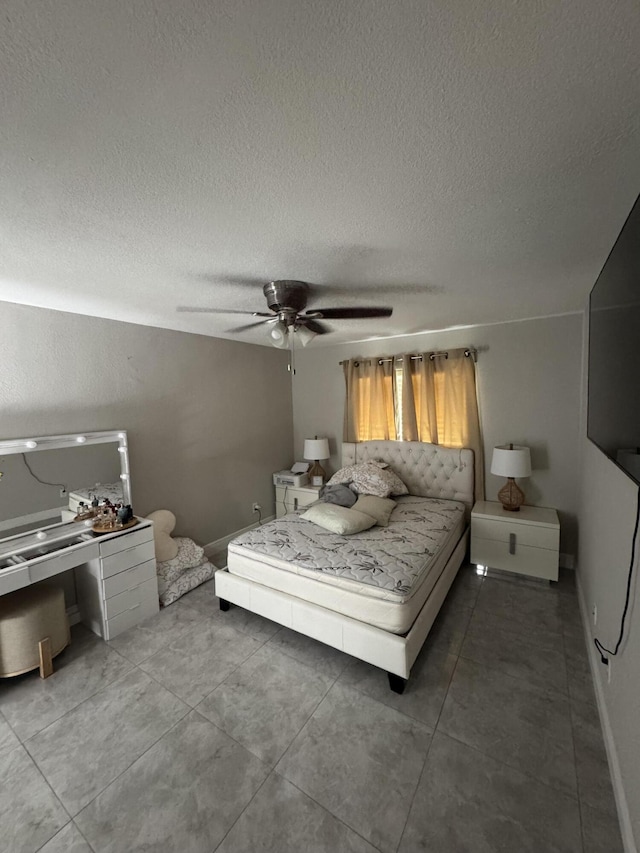 305 E 6th St, Lehigh Acres, FL 33972 - bedroom with a textured ceiling, ceiling fan, and light tile patterned floors