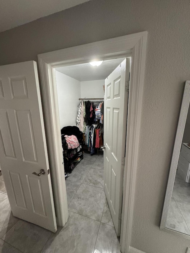305 E 6th St, Lehigh Acres, FL 33972 - hall featuring a textured wall and light tile patterned floors
