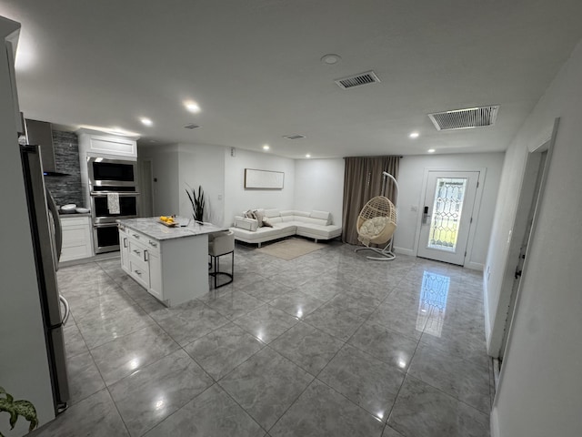 305 E 6th St, Lehigh Acres, FL 33972 - living area with recessed lighting and baseboards