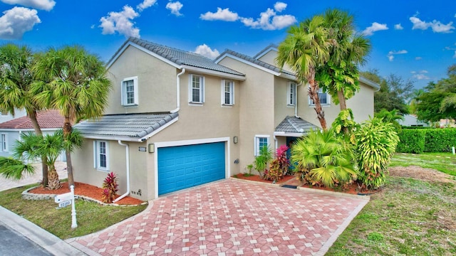22360 Overture Cir, Boca Raton, FL 33428 - view of front facade with an attached garage, decorative driveway, a tiled roof, and stucco siding