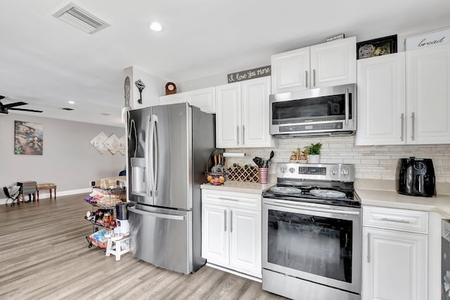 22360 Overture Cir, Boca Raton, FL 33428 - kitchen with stainless steel appliances, light countertops, backsplash, white cabinetry, and recessed lighting
