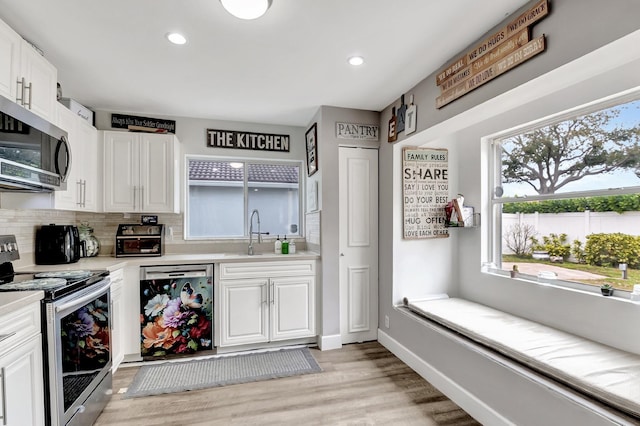 22360 Overture Cir, Boca Raton, FL 33428 - kitchen featuring stainless steel appliances, a sink, tasteful backsplash, light countertops, and white cabinetry