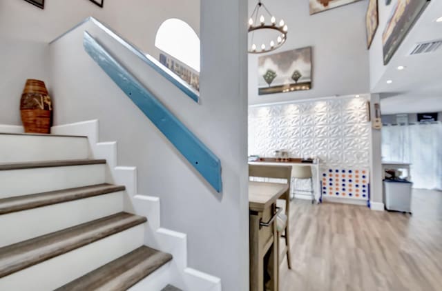 22360 Overture Cir, Boca Raton, FL 33428 - staircase featuring a chandelier, wood finished floors, and baseboards
