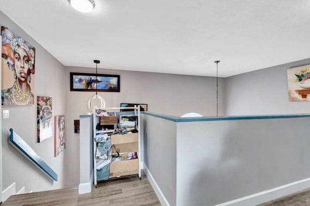 22360 Overture Cir, Boca Raton, FL 33428 - hallway with wood finished floors, an upstairs landing, and baseboards
