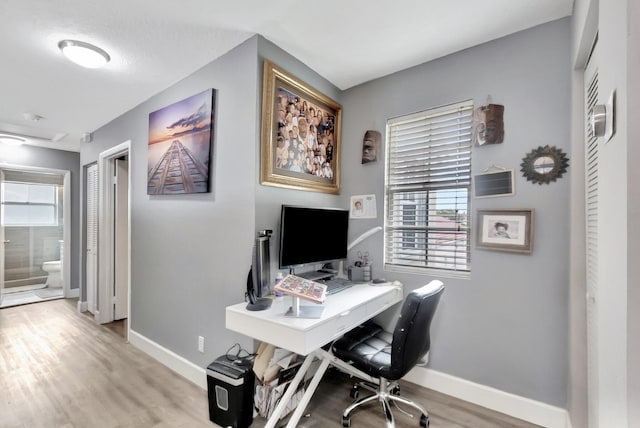 22360 Overture Cir, Boca Raton, FL 33428 - home office featuring baseboards, healthy amount of natural light, and light wood-style flooring