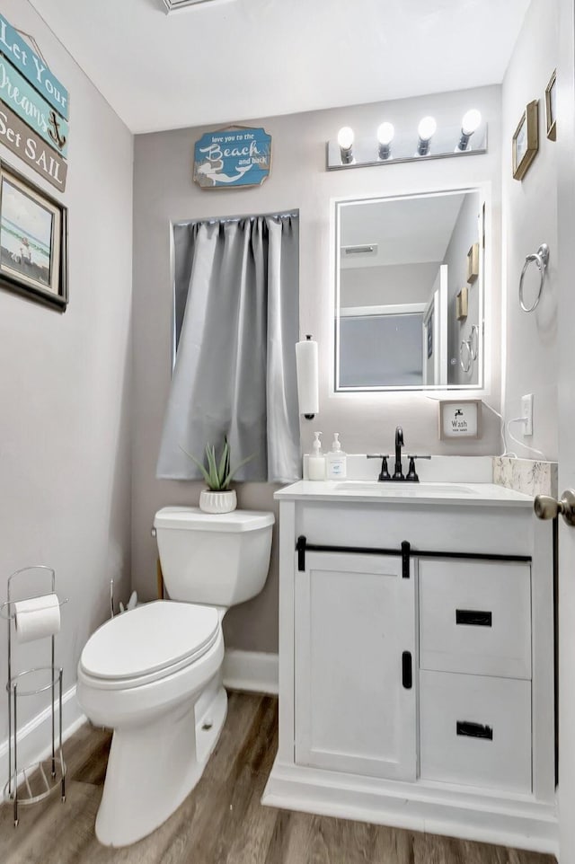 22360 Overture Cir, Boca Raton, FL 33428 - bathroom with toilet, vanity, wood finished floors, and baseboards