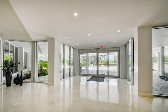 3546 S Ocean Blvd Unit 203, South Palm Beach, FL 33480 - common area featuring recessed lighting and a wall of windows