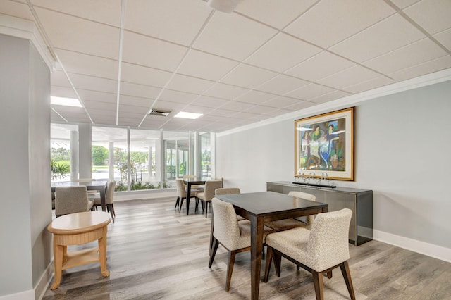 3546 S Ocean Blvd Unit 203, South Palm Beach, FL 33480 - dining area with baseboards, a drop ceiling, and light wood finished floors